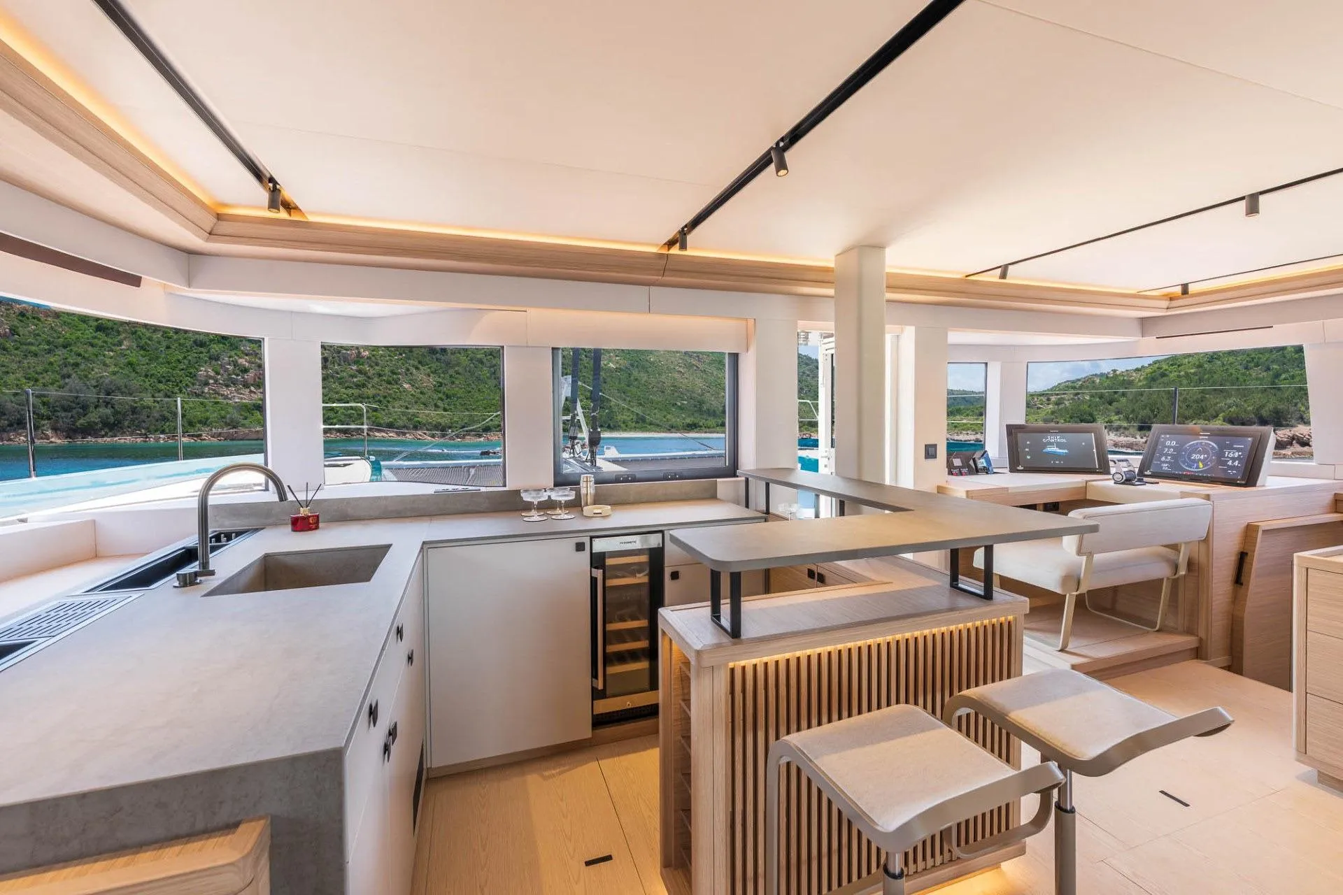 Open galley and bar of the Lagoon Eighty2 with panoramic views over the anchorage
